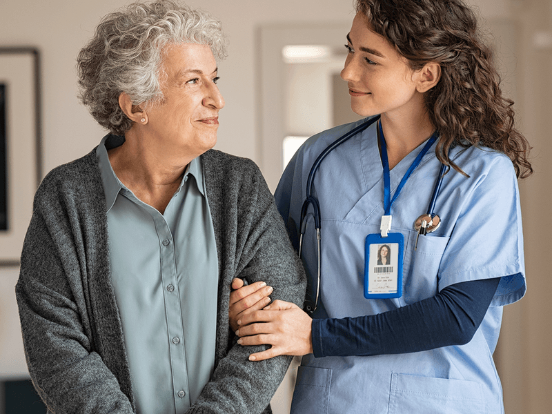 Nurse assisting patient in aged care setting
